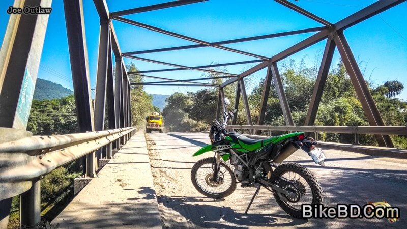 kawasaki dirt bike on a bridge